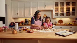 Woman and child baking in kitchen