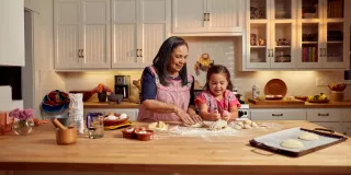 Woman and child baking in kitchen